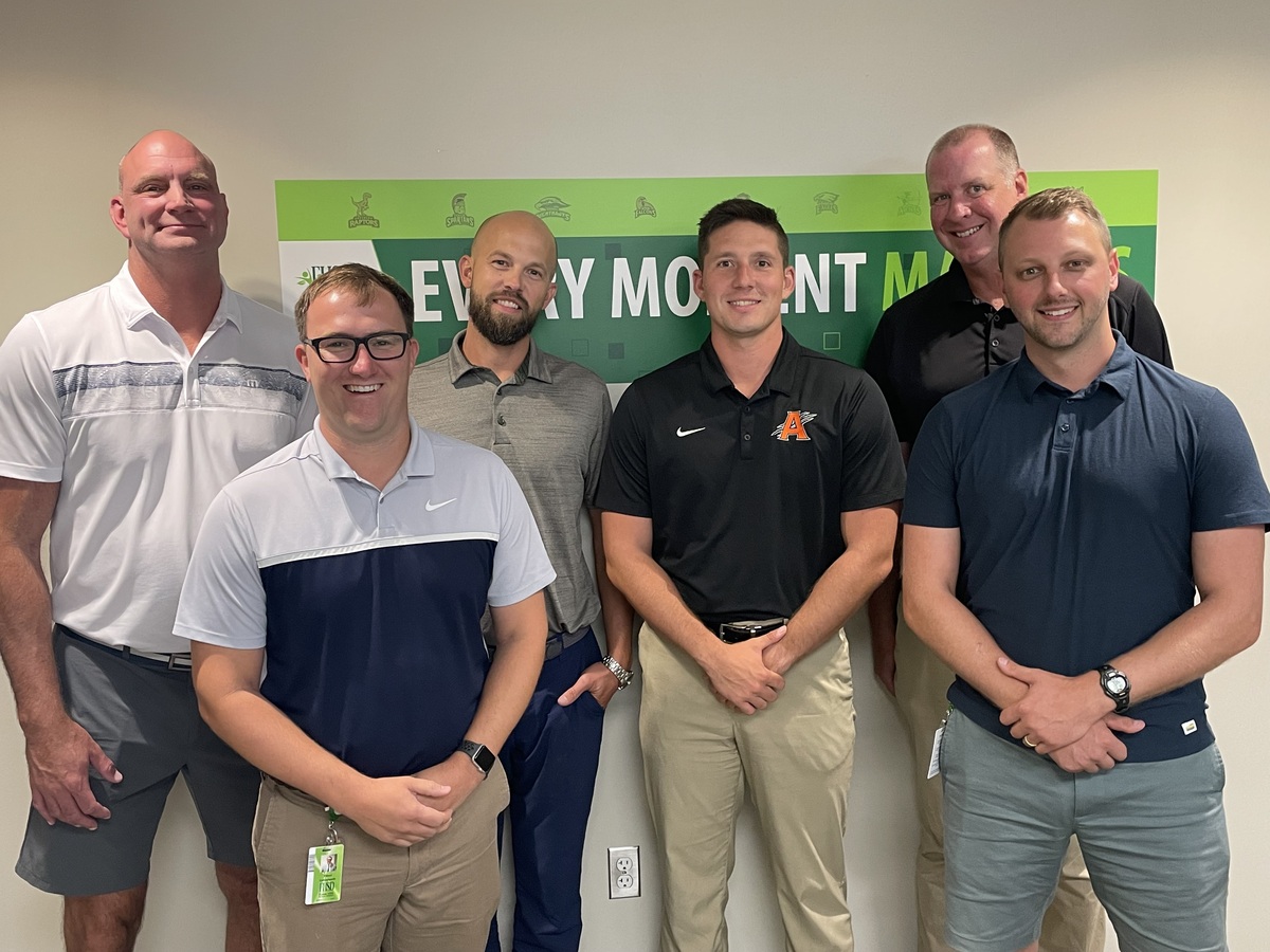 FHSD's six newest administrators pose for a photo in front of a sign that reads "Every Moment Matters"